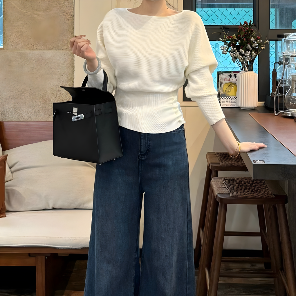 Relaxed fit women's off-the-shoulder sweater in a cozy knit, ideal for versatile casual wear.