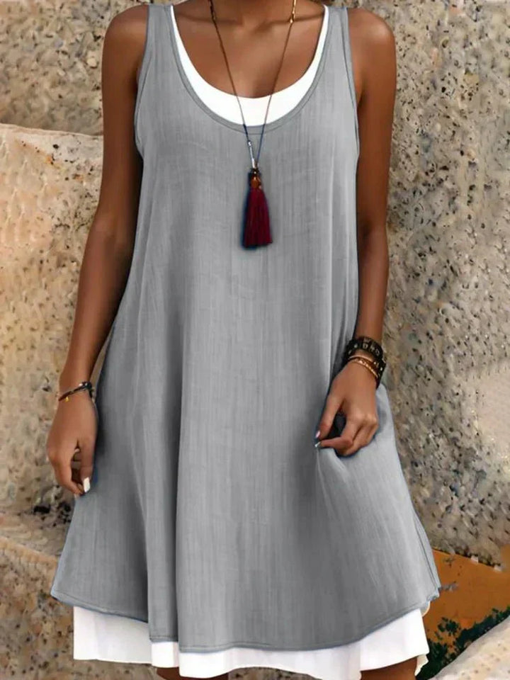 Comfortable sleeveless layered mini dress for women, with a swing style and scoop neck, ideal for casual wear.