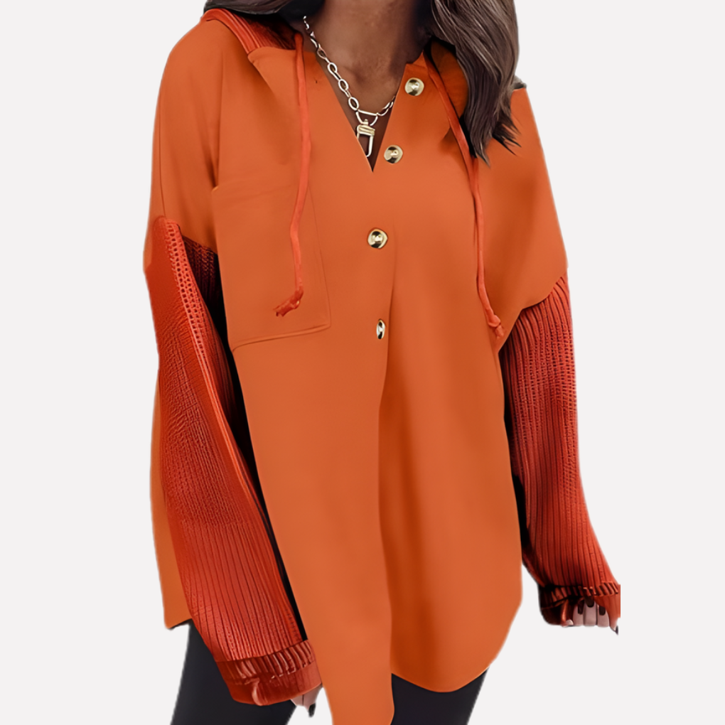 Woman wearing a relaxed fit oversized hooded sweatshirt. Comfortable long sleeve casual loungewear.