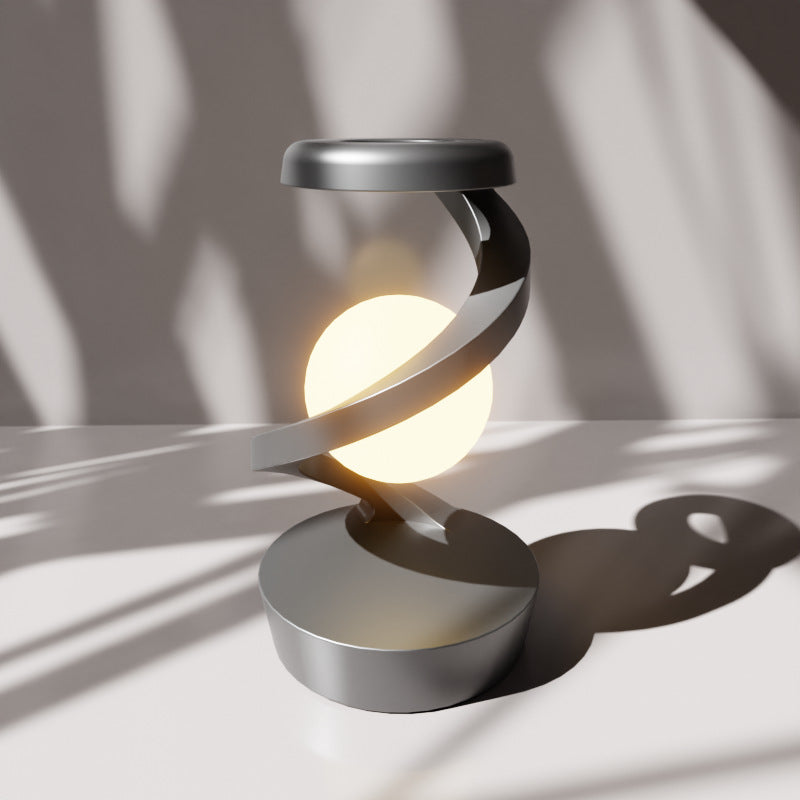 Modern spiral LED desk lamp, gray finish, for home & office accent lighting. Emits warm light, contemporary decorative lamp.