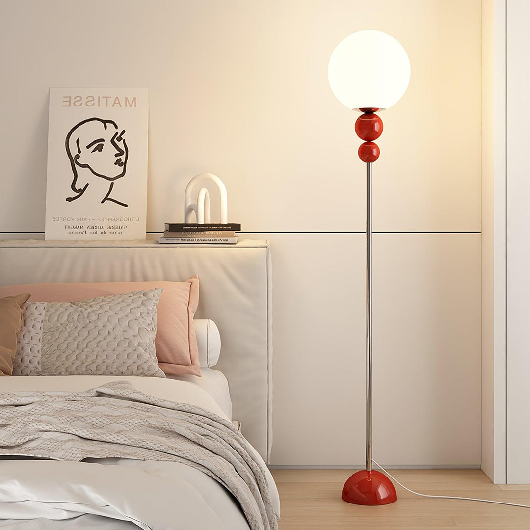 Contemporary red floor lamp, metal and glass, perfect for a cozy bedroom light.