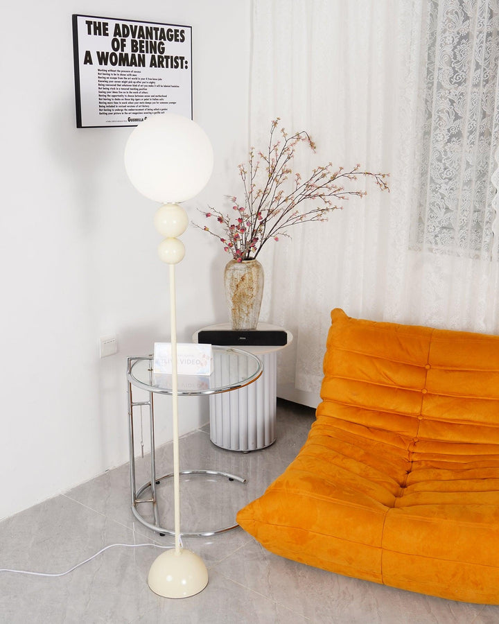 Milky white metal & glass floor lamp, providing sophisticated ambient light.