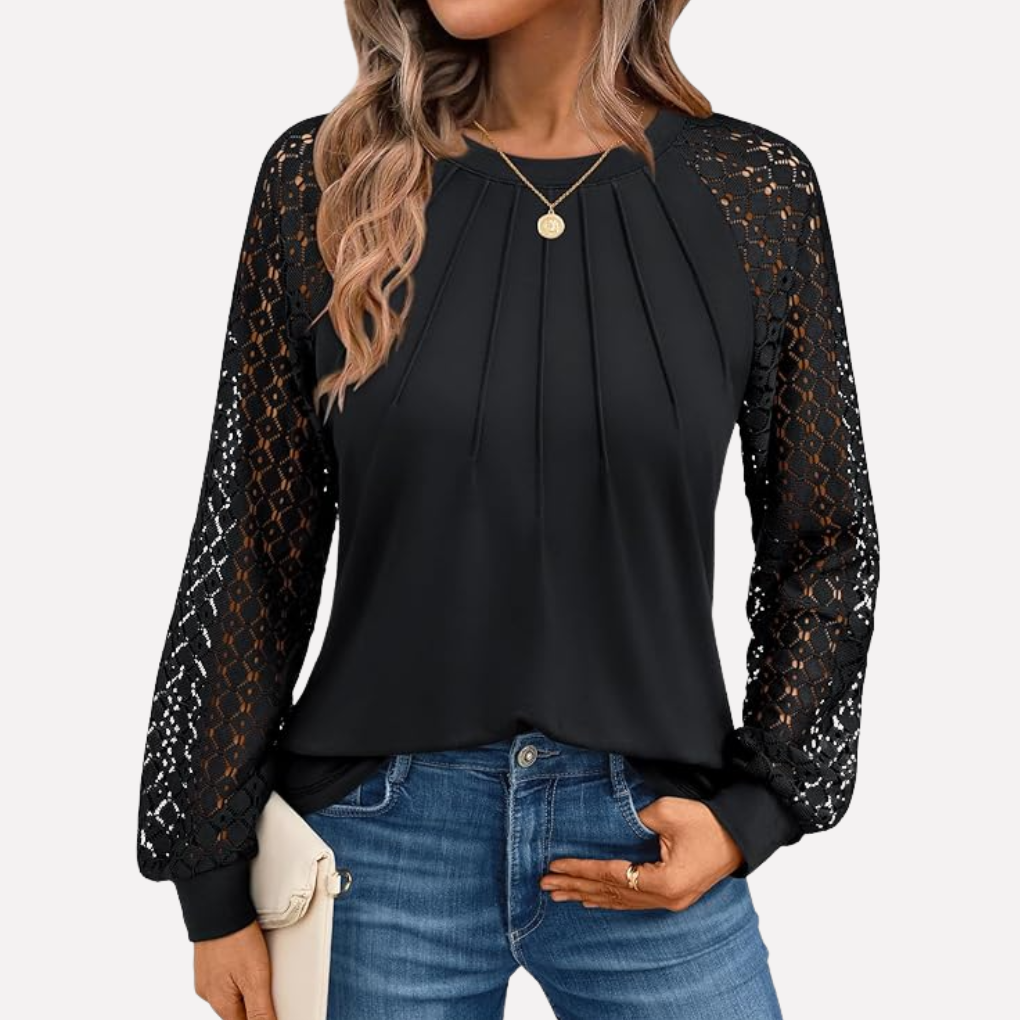 Close-up of a women's long-sleeve blouse featuring intricate lace details and stylish pleats.
