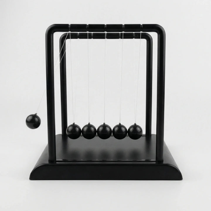 Close-up of modern kinetic desk ornament creating calming motion, ideal for tabletop and office decor.