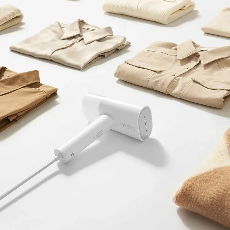 Efficient Tavvitaimp18 fabric steamer & iron for gentle wrinkle removal, garment care, and mite sanitization.