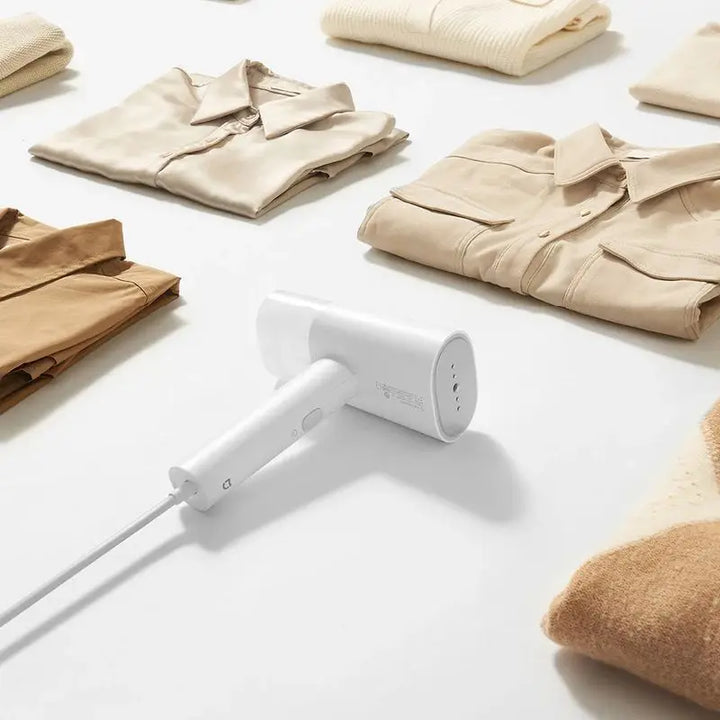 Efficient Tavvitaimp18 fabric steamer & iron for gentle wrinkle removal, garment care, and mite sanitization.