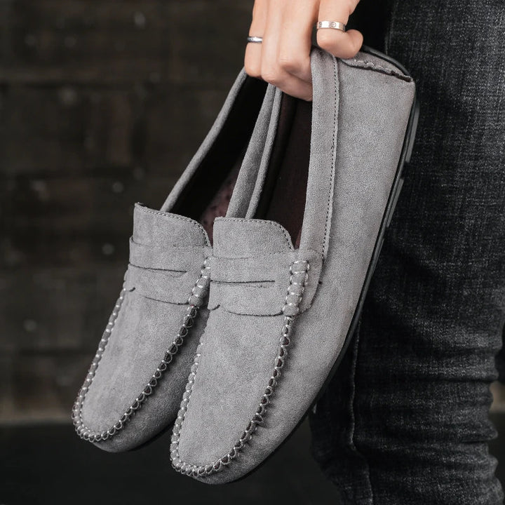 Close-up of Men's Tivoli penny loafers, showcasing the premium leather texture & meticulous stitching for durability.