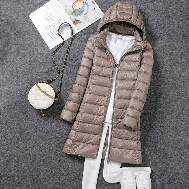 Warm women's long hooded puffer outerwear, insulated for supreme cold weather protection & cozy fit.