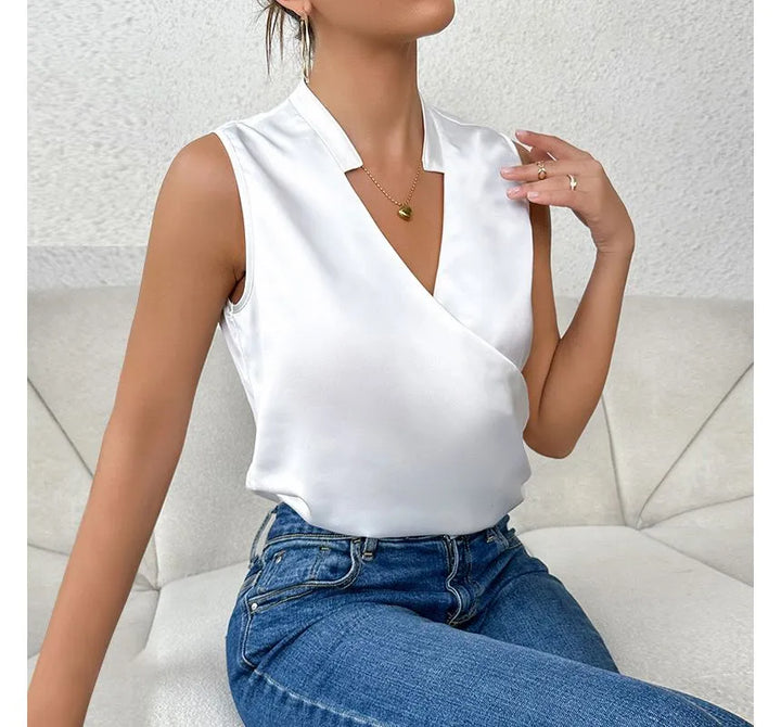 Elegant black sleeveless women's top, flattering fit, highlighting shoulders, ideal for casual or formal occasions.