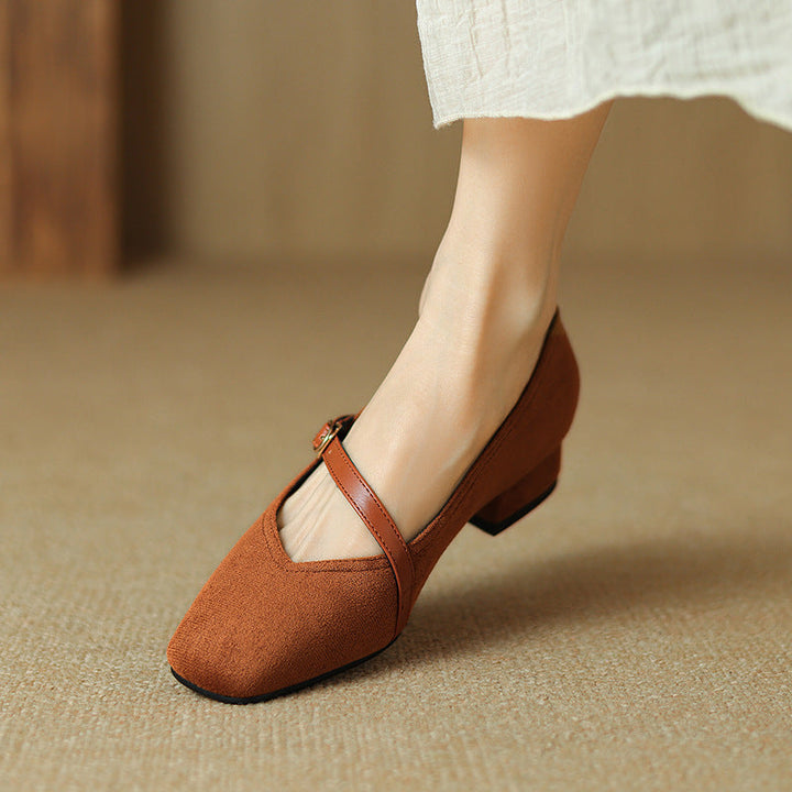 Black suede buckle strap block heel pumps, an essential addition to women's elegant footwear.