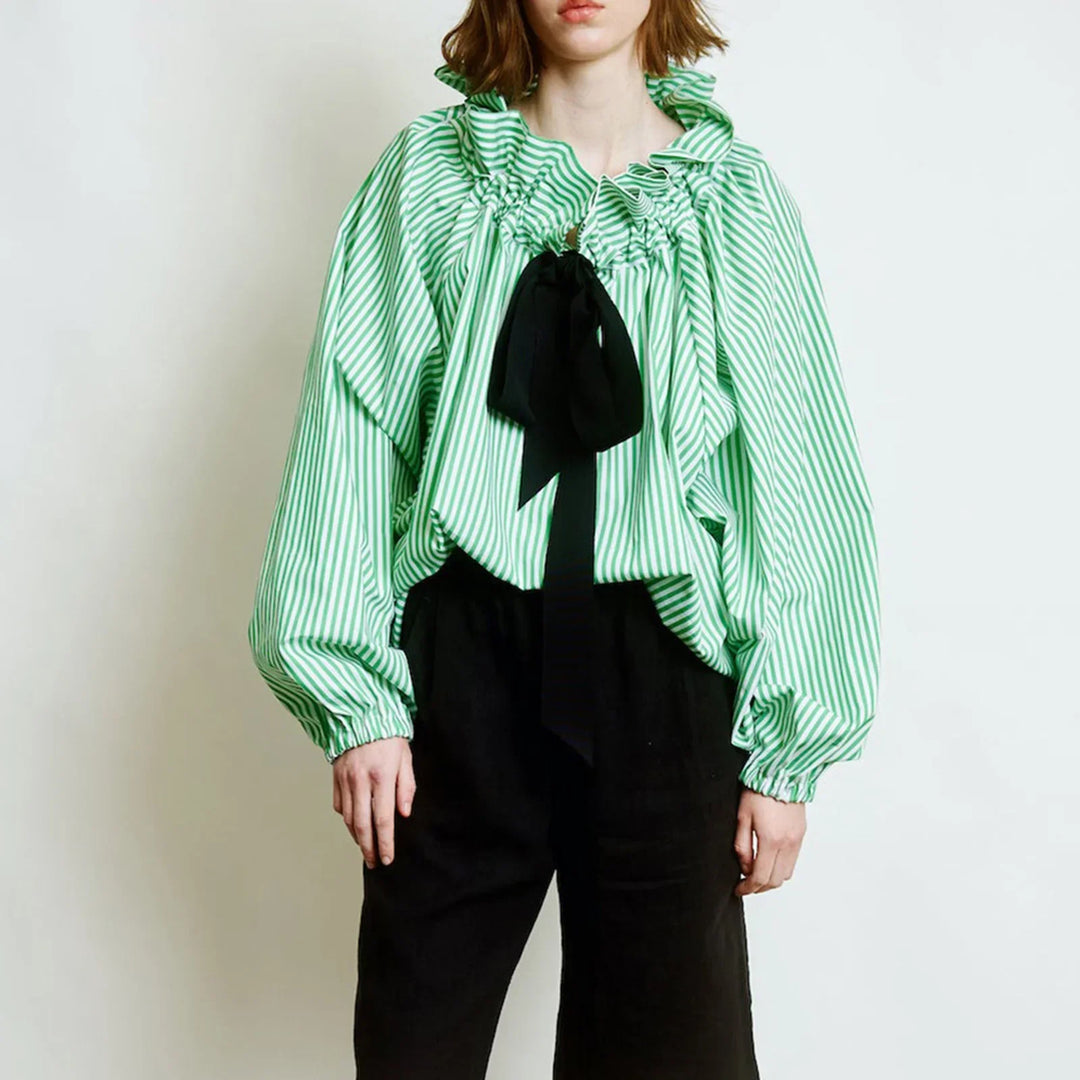 Detail of the puffed lantern sleeve on a white women's blouse, highlighting the elegant design.