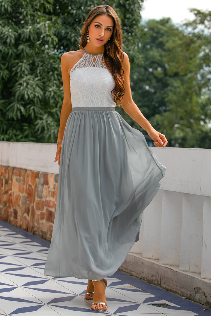 Elegant women's halter neck maxi dress in a flowing fabric, perfect for a wedding guest or formal event.