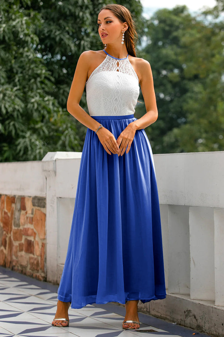 Halter neck maxi dress paired with subtle accessories, ideal for a wedding or gala evening.