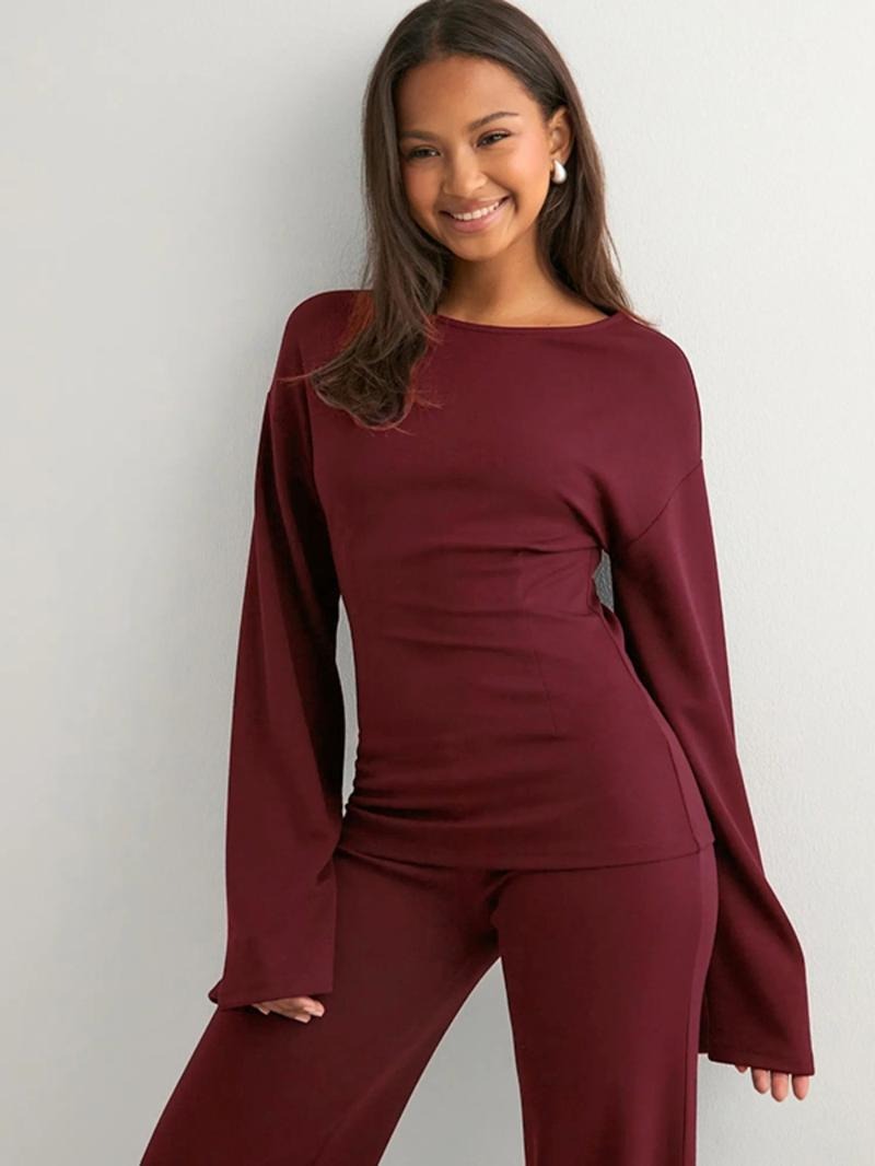 Elegant women's knit lounge wear set with flared top and wide-leg pants, soft & cozy