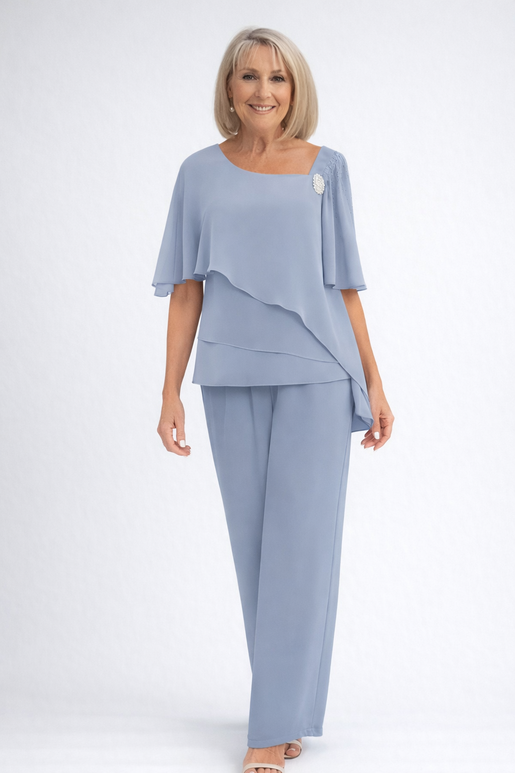Elegant women's two-piece set featuring a tiered cape top and flowing wide-leg trousers, perfect for special occasions.