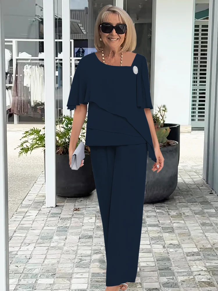 Chic women's trouser set with a cape top & wide-leg pants. Versatile smart casual or event attire ensemble.