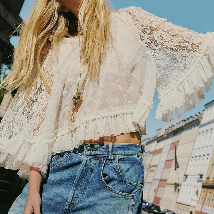 Elegant women's white lace blouse with delicate floral embroidery and sheer ruffle details, perfect for summer dressy occasions