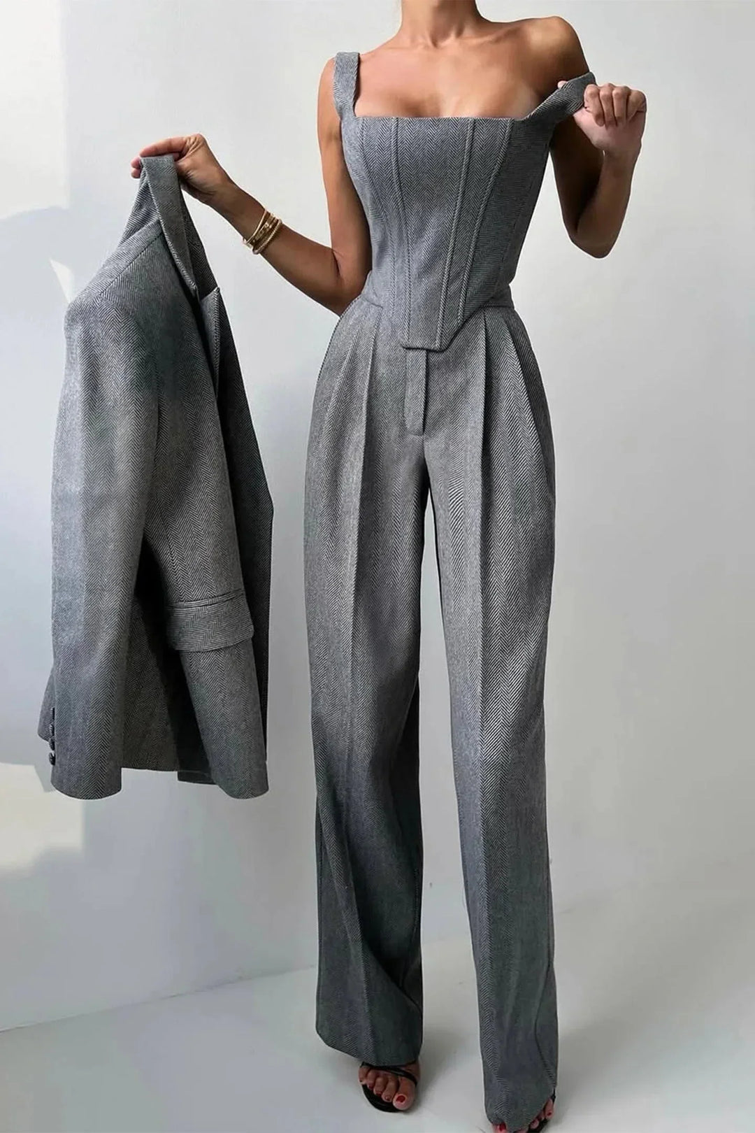 Detail shot of women's corset bustier from a 3-piece set, paired with wide leg pants & a blazer. Evening wear.