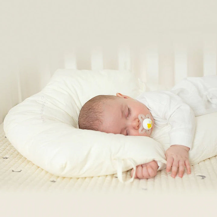Baby organic cotton head support pillow, U-shape for gentle sleep, newborn comfort essential.