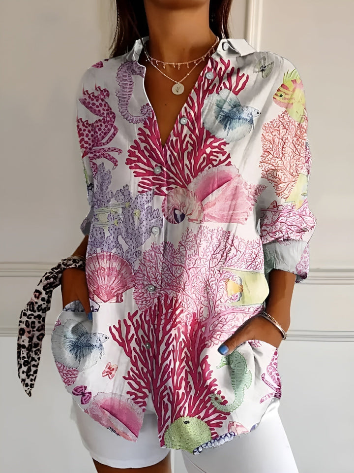 "Lightweight women's button-down summer blouse with classic collar, full-length sleeves, in breathable fabric for sunny days.