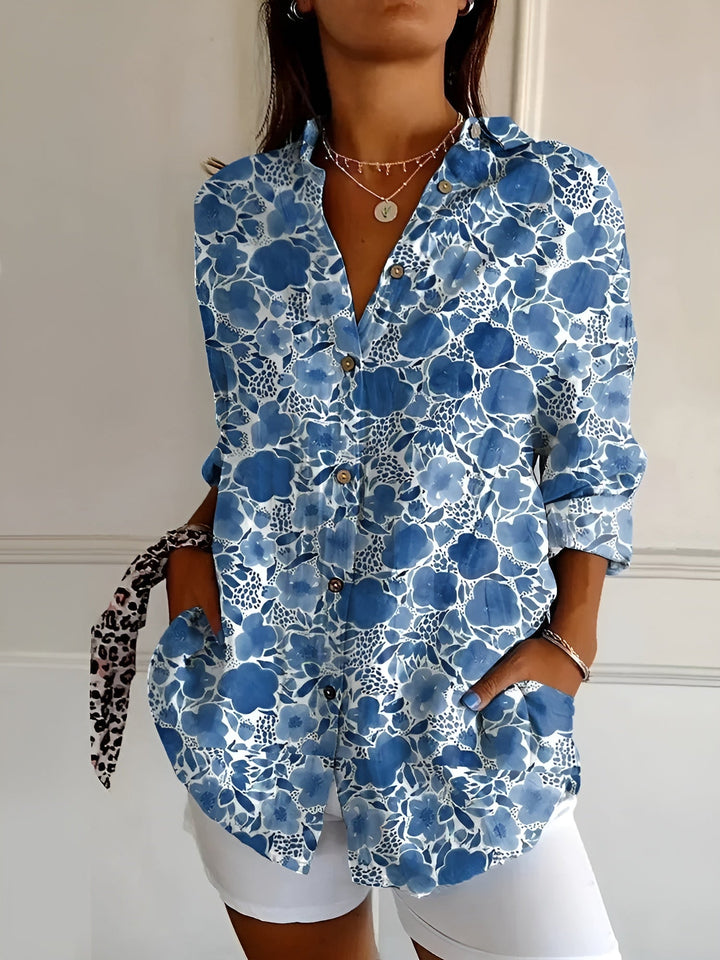 "Lightweight women's button-down summer blouse with classic collar, full-length sleeves, in breathable fabric for sunny days.