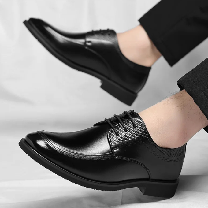 Front view of men's classic black leather dress shoes, perfect for professional or special occasions