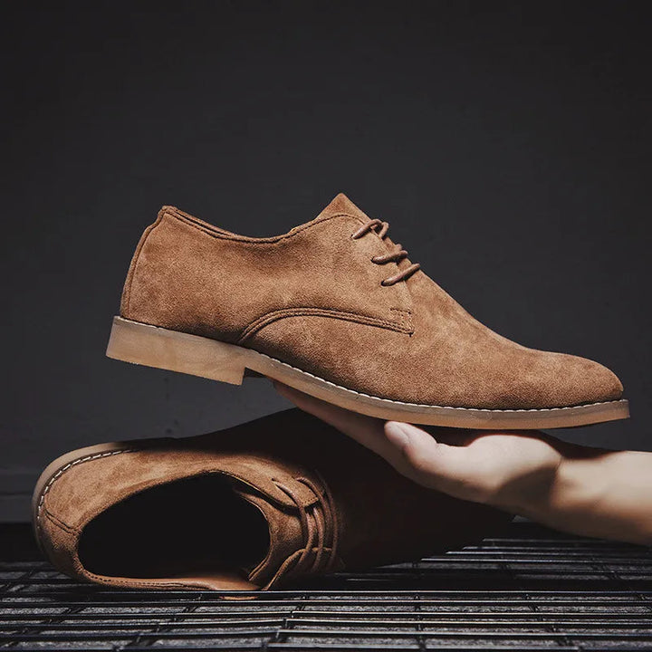 Stylish men's grey suede Oxford shoes, exhibiting fine craftsmanship and comfortable design.