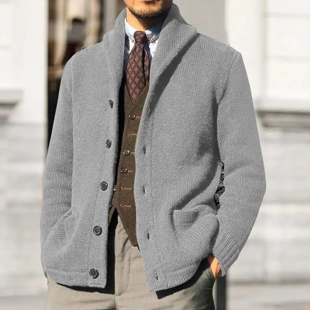 Detailed shot of the buttons and ribbed trim on a comfortable men's cable knit cardigan sweater.