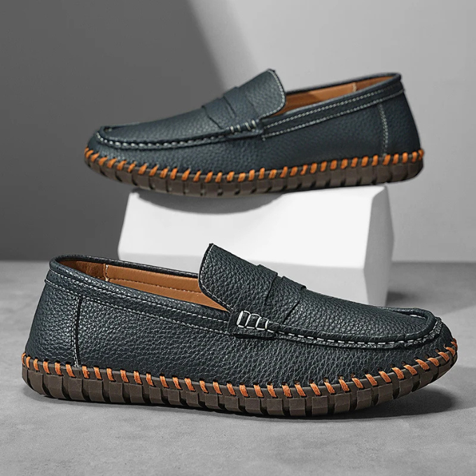 A man wearing black full-grain leather loafers with business casual attire