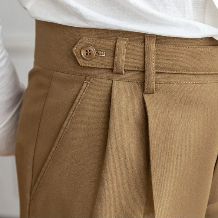 Men's straight leg dress pants laid flat, showcasing the precise tailoring and straight cut