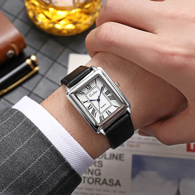 Close-up of a men's classic square watch, showing the detailed dial and durable leather strap.