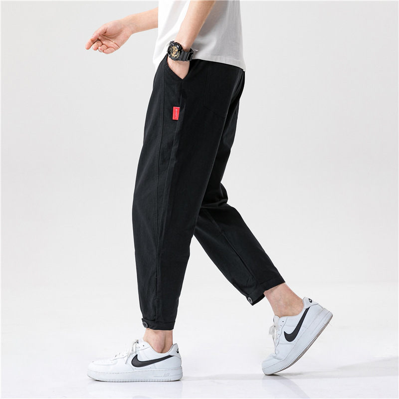 Studio shot of men's gray linen blend tapered cropped casual pants, ideal for summer