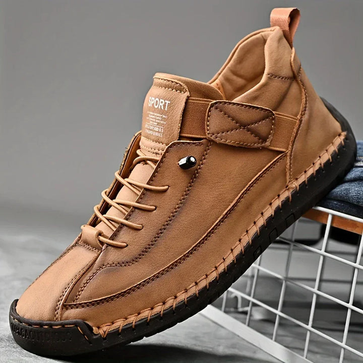 Detail of the stitching on men's black leather orthopedic sneakers, emphasizing quality and design.