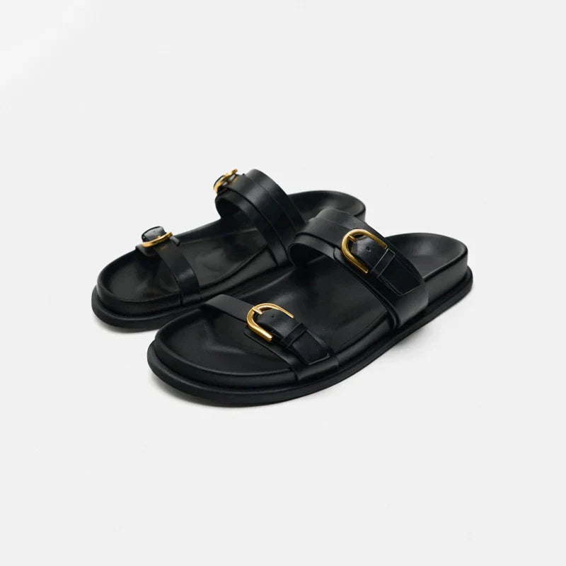 Close-up of men's leather slide sandal showing stitching and premium material