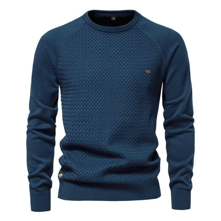 Full length view of a man wearing a stylish waffle knit crewneck sweater with jeans