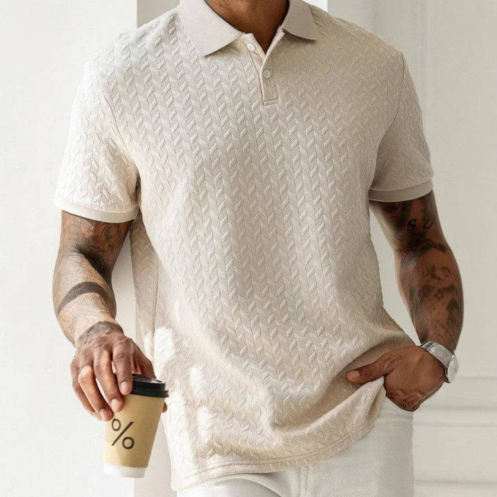 Close-up of men's textured polo shirt fabric, highlighting quality & refined detail for smart casual look.