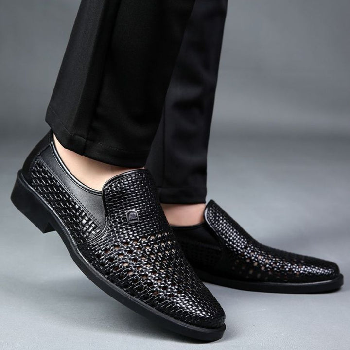 Close-up of men's leather slip-on loafers, highlighting intricate woven texture & high quality.