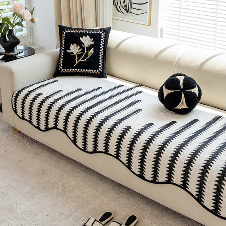 Stylish modern chevron sofa cover featuring unique wavy edges. Transforms and protects living room furniture.