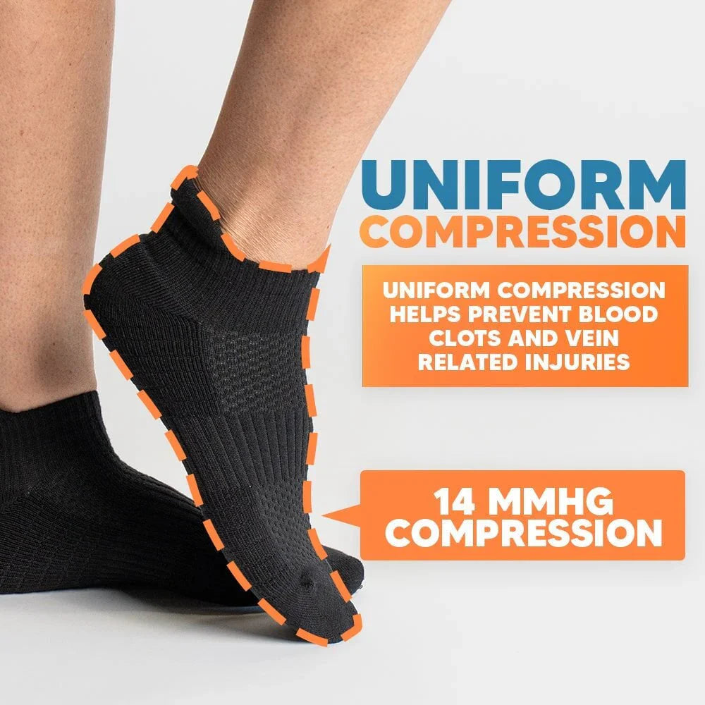 Detail shot of the elastic cuff of a gray ankle compression sock, providing snug ankle support.