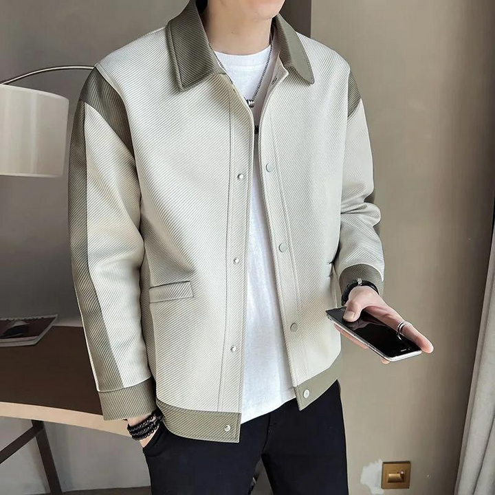 Stylish men's patchwork jacket featuring a lapel collar & snap button closure. Unique long-sleeve casual outerwear.