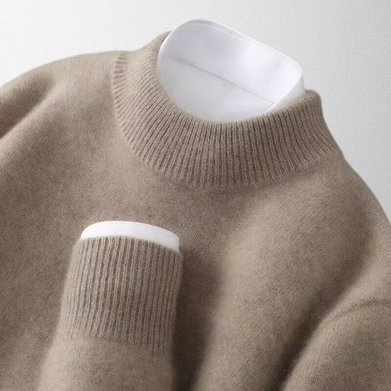 Cream-colored unisex cashmere pullover sweater, showcasing its soft texture and classic crew neck design.
