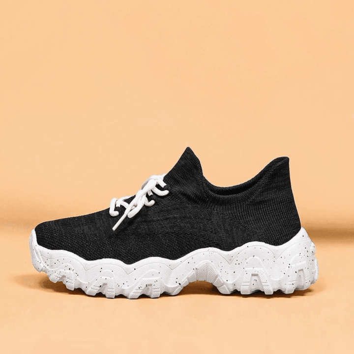 Side view of the orthopedic shoes, showing their robust construction and cushioning.