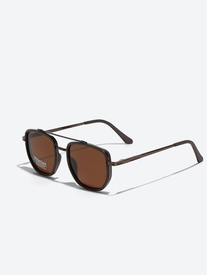 Close-up of unisex polarized sunglasses showing a modern gold metal frame & dark lenses for optimal UV protection