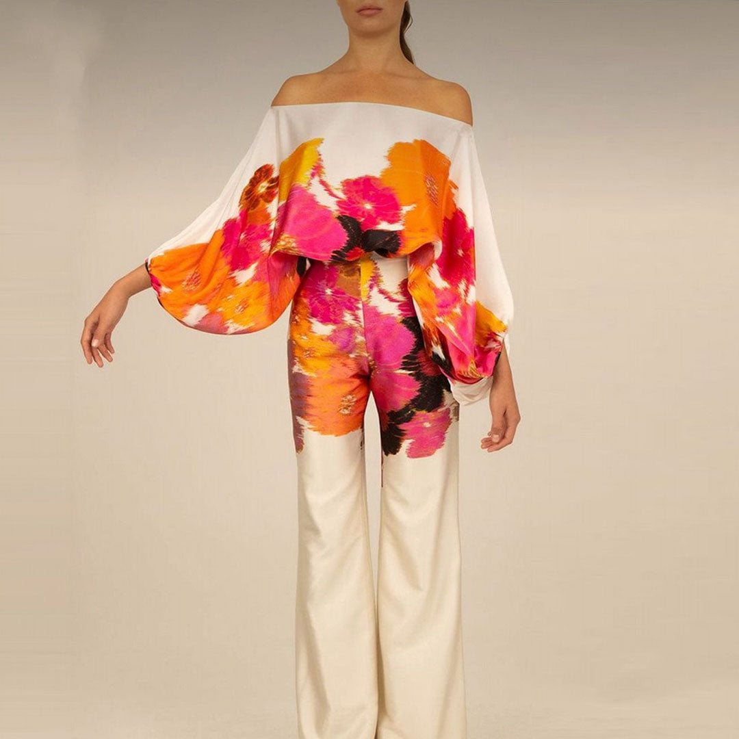 Women's artistic one-shoulder printed two-piece pants set, showcasing the flowy wide-leg pants and abstract design.