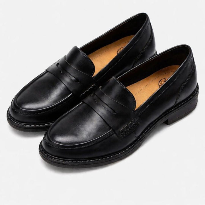 Detailed shot of the stitching and craftsmanship on a pair of women's leather loafers