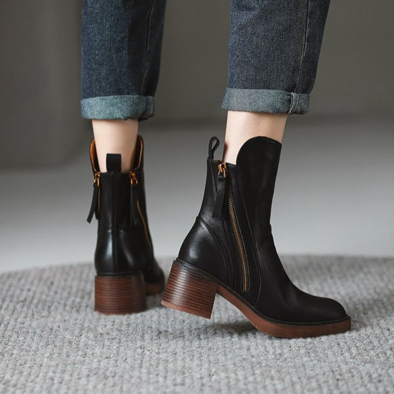 Detail shot of the block heel on women's leather zip ankle boots, highlighting stability and design