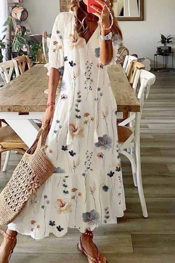 Women's boho floral maxi dress with tassel V-neck. Perfect for summer, beach vacations, or a stylish festival outfit.