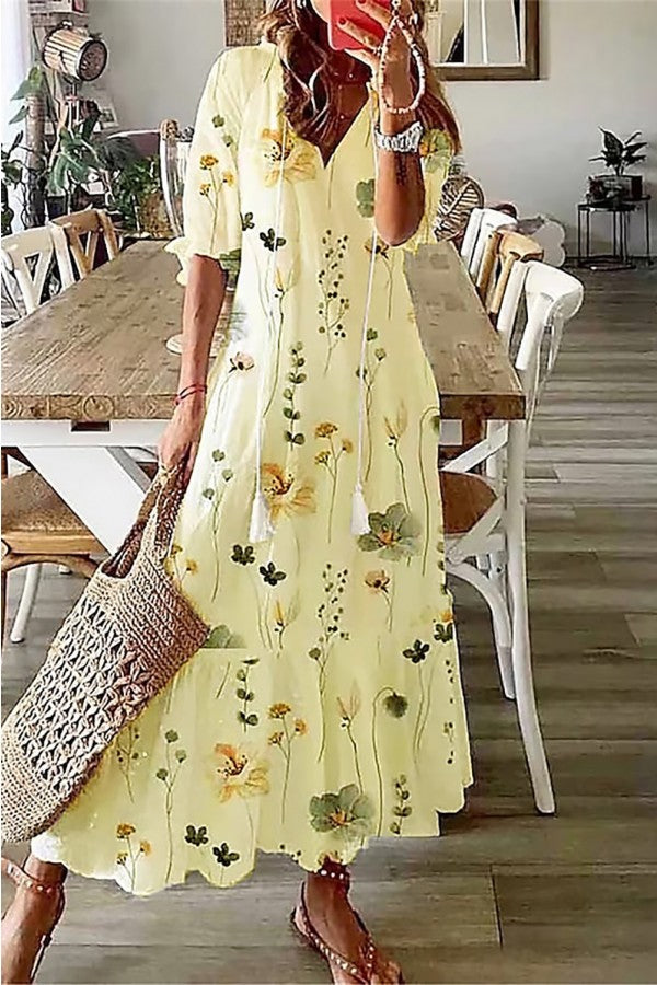 Summer women's boho maxi dress, featuring a vibrant floral pattern & stylish tassel V-neck. Great for vacation.