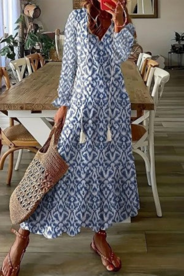 Elegant women's summer boho floral maxi dress with a charming tassel V-neck. Ideal for beach, festival, or casual chic.