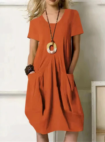 Women's casual gathered midi dress with short sleeves & practical pockets, ideal for summer everyday wear in black.